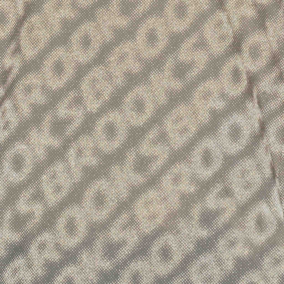 Close-up view of the reflective print on the Brooks Women's Canopy Reflective Jacket in the Reflective Wordmark Bone colourway.