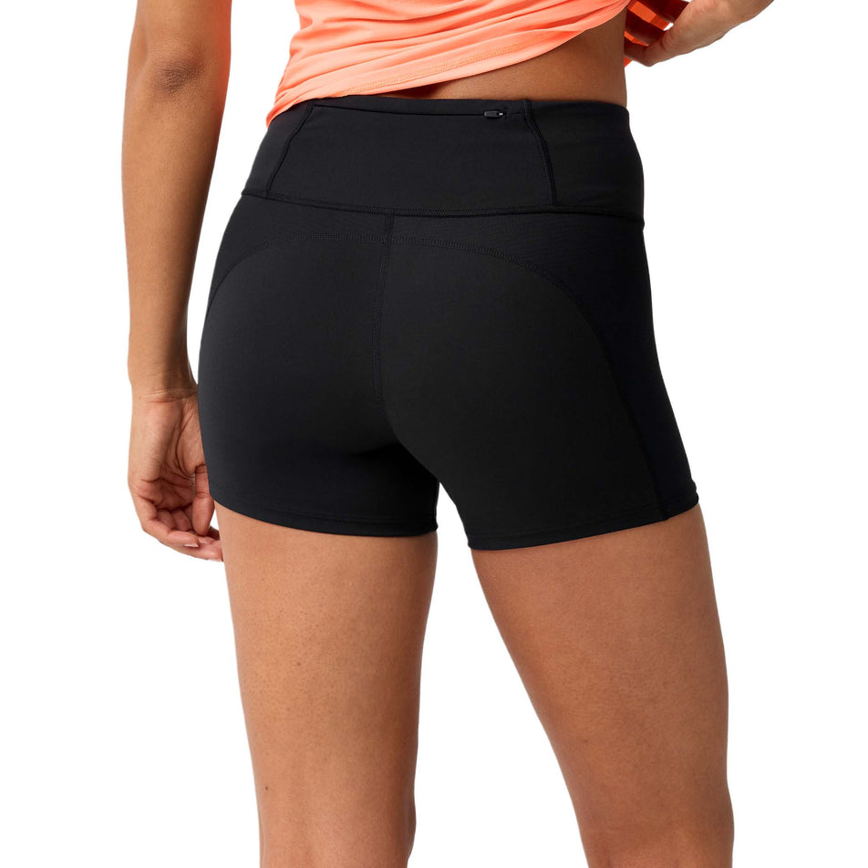 Back view of a model wearing the Brooks Women's Dash Cooling Short in the Black colourway.