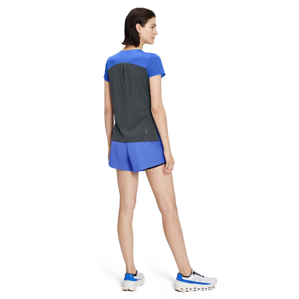 Back view of a model wearing a pair of On Women's Running Shorts in the Cobalt/Black colourway - with an On T-Shirt (7926184444066)