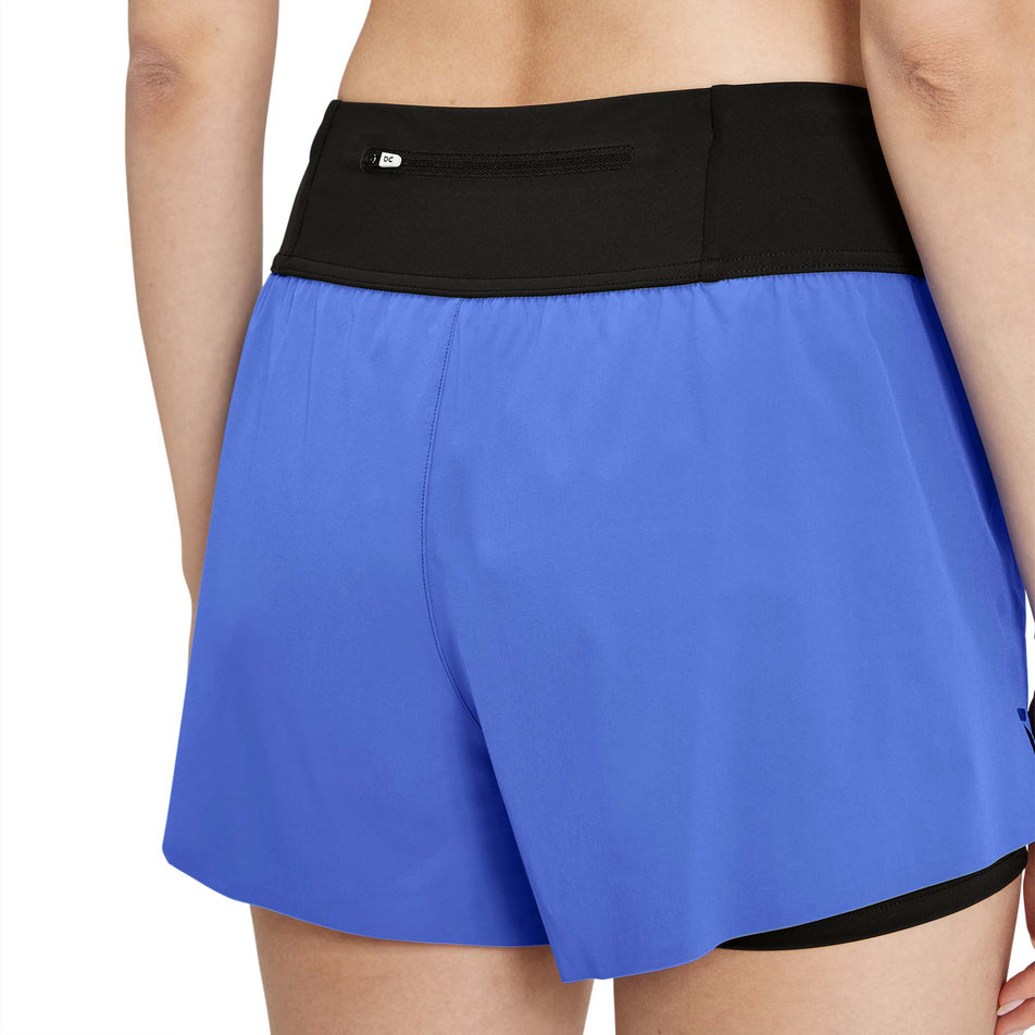 Back view of a model wearing a pair of On Women's Running Shorts in the Cobalt/Black colourway (7926184444066)