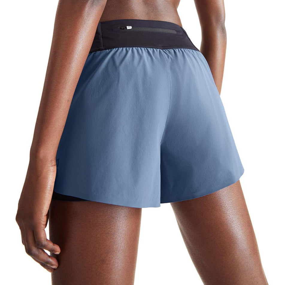 Close-up back view of a model wearing a pair of On Women's Running Shorts in the Stellar/Black colourway (8002757591202)