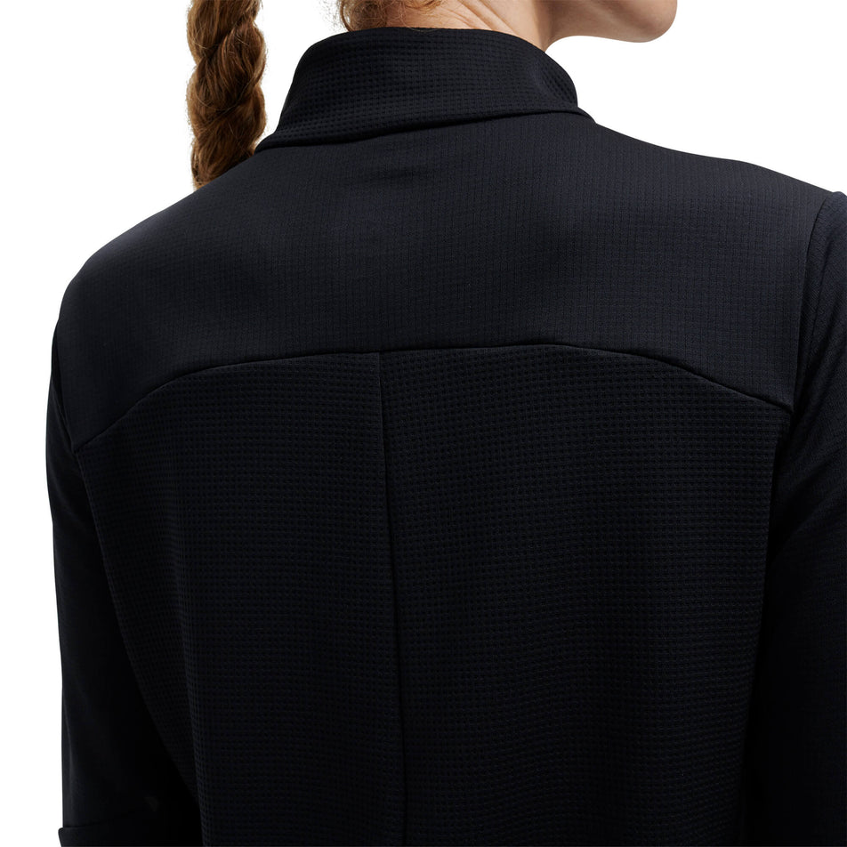 Close-up back view of the upper section of an On Women's Climate Shirt in the black colourway - being worn by a model (7920996286626)