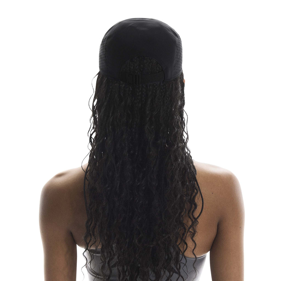 Back view of a model wearing the On Unisex Lightweight Cap in the Black colourway.