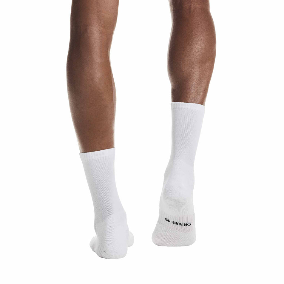 Back view of a model wearing a pair of On Unisex Core Run Sock High 2P in the White colourway.