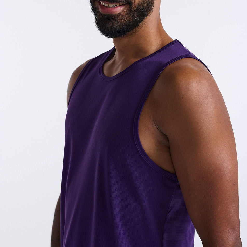 Close-up angled front view of a model wearing a 2XU Men's Aero Tank in the Acai/Black Reflective colourway. The upper section of the 2XU tank can been seen in the image (8248599052450)
