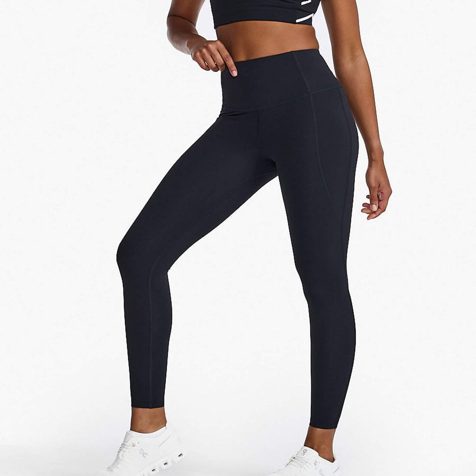 Front view of a model wearing a pair of 2XU Women's Form Hi-Rise Compression Tights in the Black/Black colourway. Model is also wearing shoes and a crop top. (8248604262562)