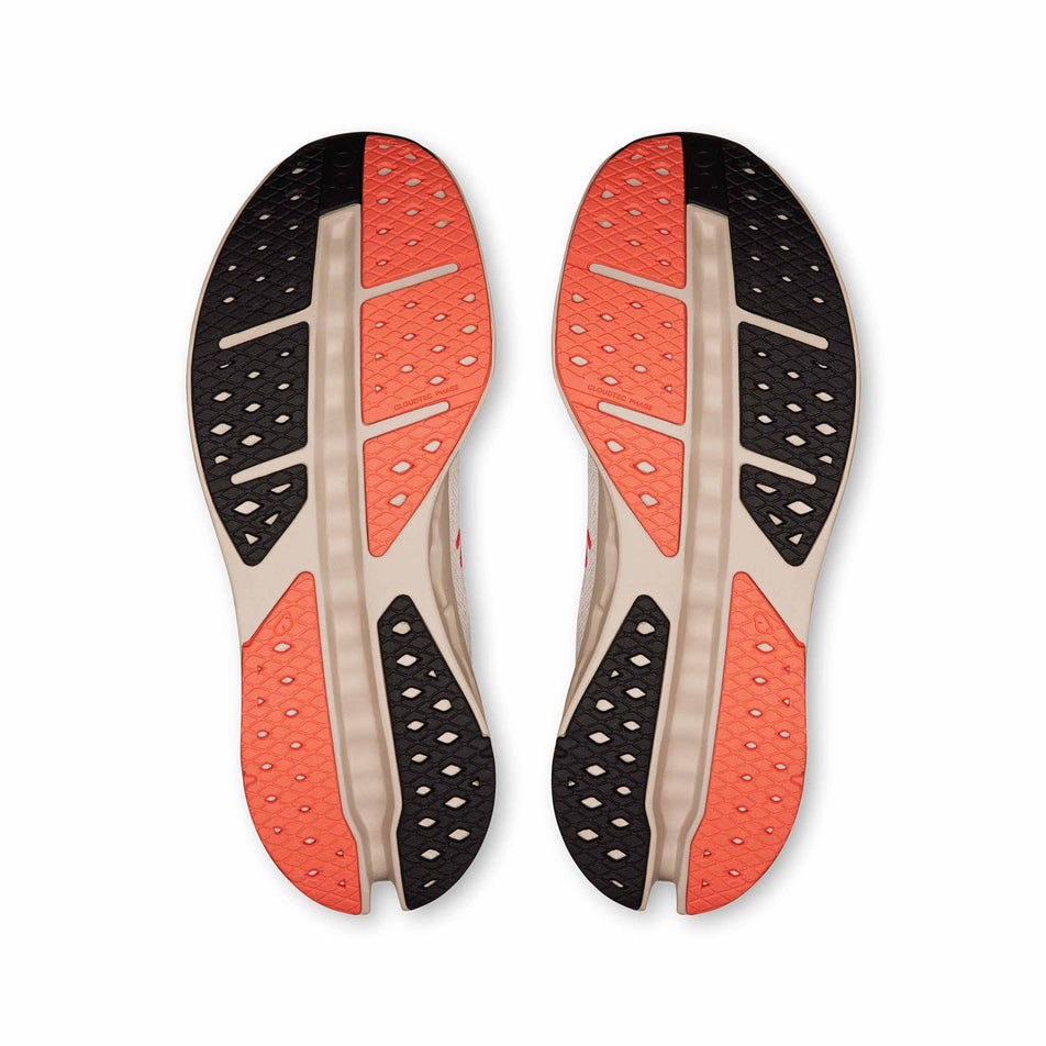 The outsoles of a pair of On Men's Cloudsurfer Max Running Shoes in the Ivory/Salmon colourway. (8714501882018)