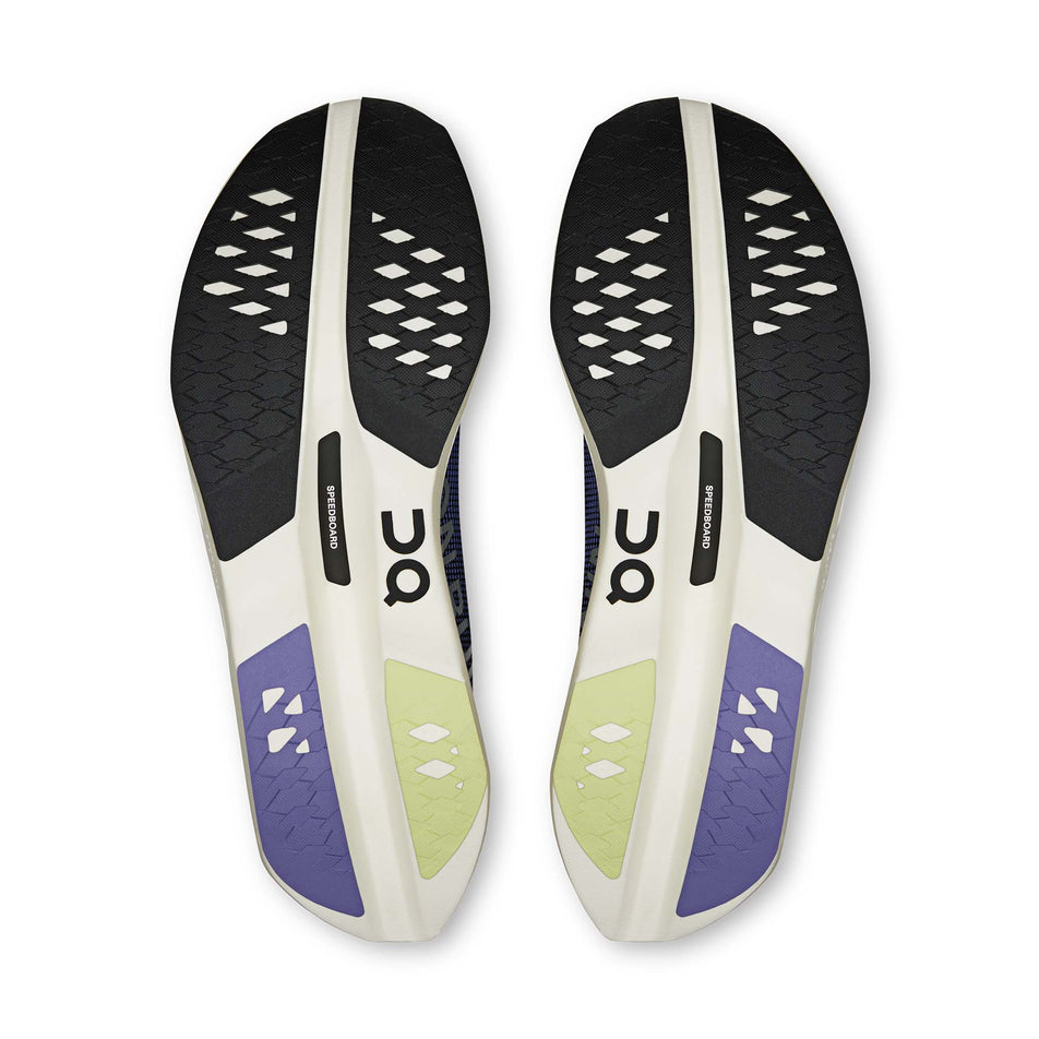 The outsoles of a pair of On Men's Cloudboom Volt Running Shoes in the Black/Juniper colourway.