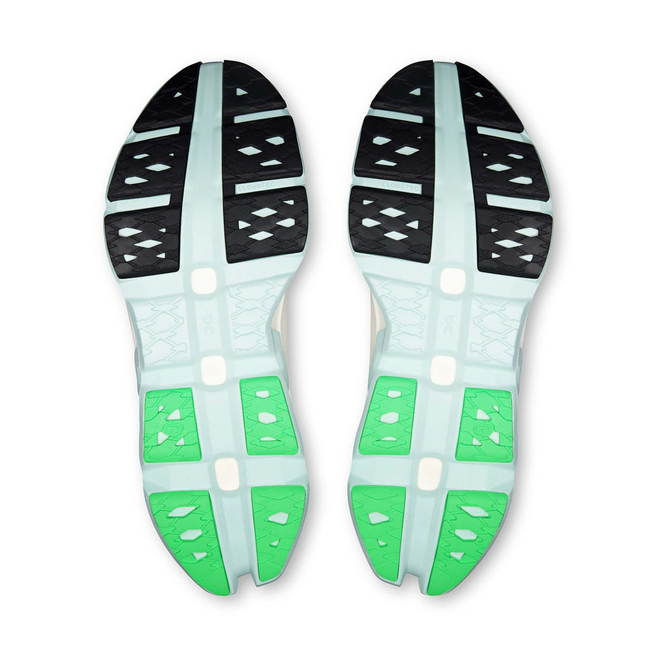 The outsoles of a pair of On Men's Cloudmonster 3 Hyper Running Shoes in the Ivory/Flurry colourway.
