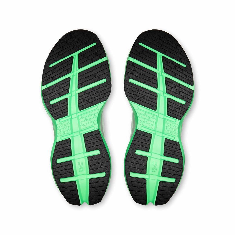 The outsoles of a pair of On Men's Cloudrunner Max Running Shoes in the White/Verdite colourway.