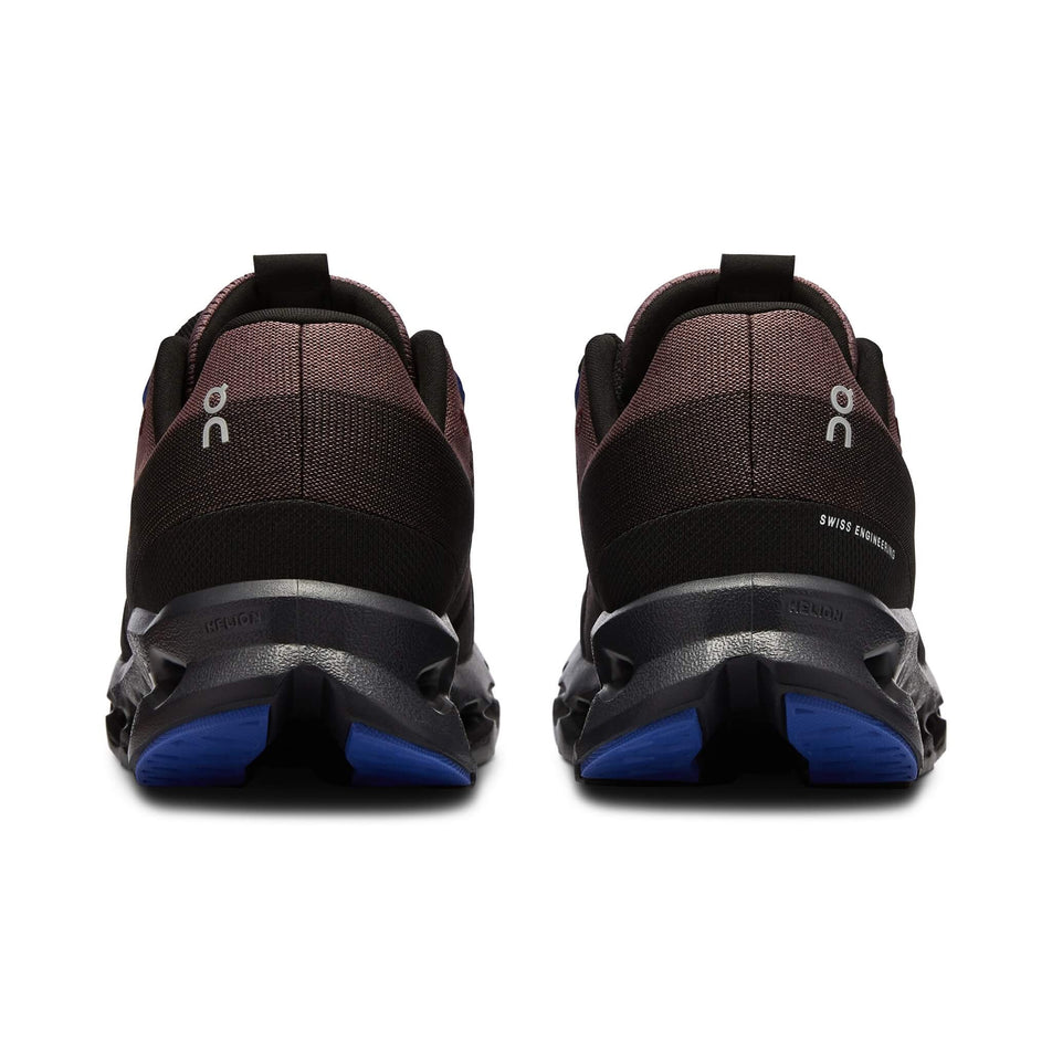 The back of a pair of On Women's Cloudsurfer Running Shoes in the Black/Cobalt colourway (8132660330658)