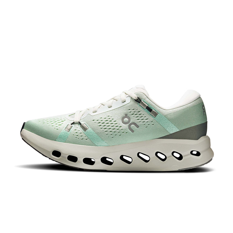 Medial view of the right shoe from a pair of On Women's Cloudsurfer 2 Running Shoes in the Ivory/Creek colourway.