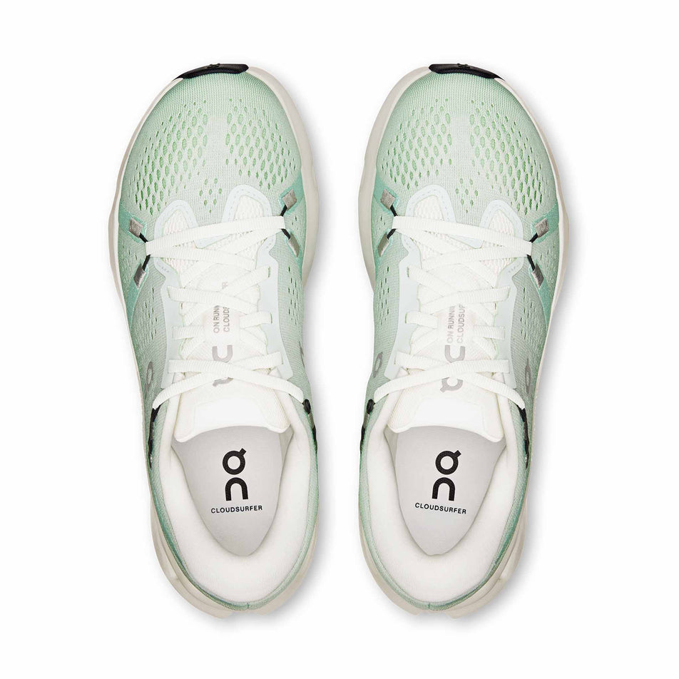 The uppers of a pair of On Women's Cloudsurfer 2 Running Shoes in the Ivory/Creek colourway.