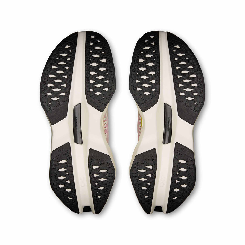 The outsoles of a pair of On Women's Cloudboom Max Running Shoes in the Lime/Raspberry  colourway. (8746029416610)