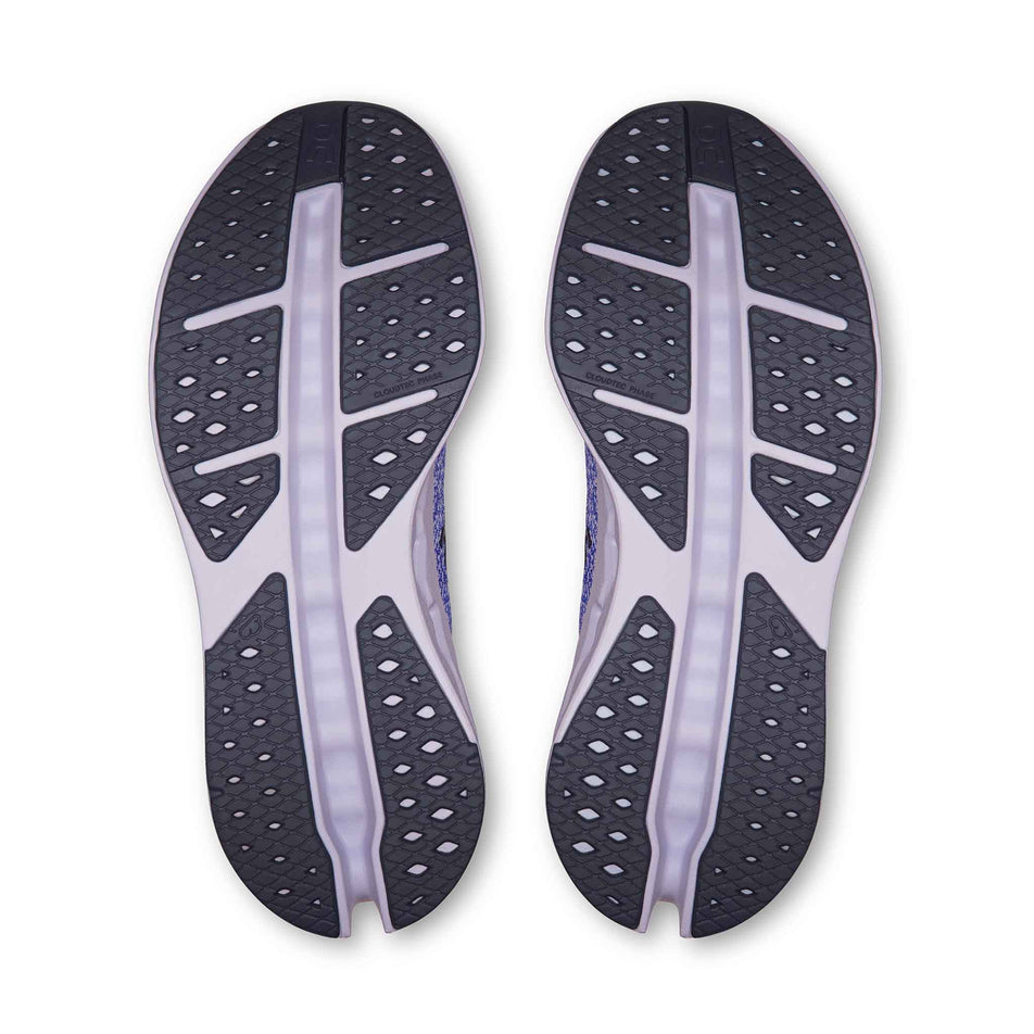 The outsoles of a pair of On Women's Cloudsurfer Max Running Shoes in the Sailor/Thistle colourway.