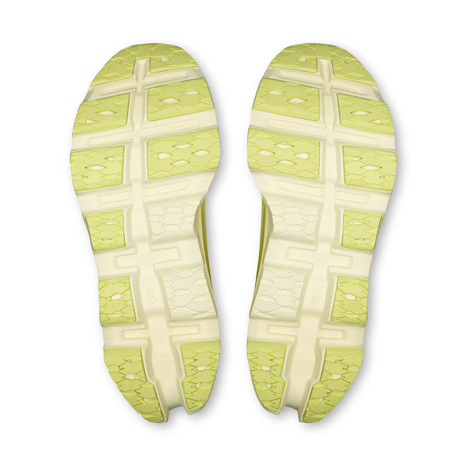 The outsoles of a pair of On Women's Cloudmonster 3 Running Shoes in the Limelight/Seedling colourway.