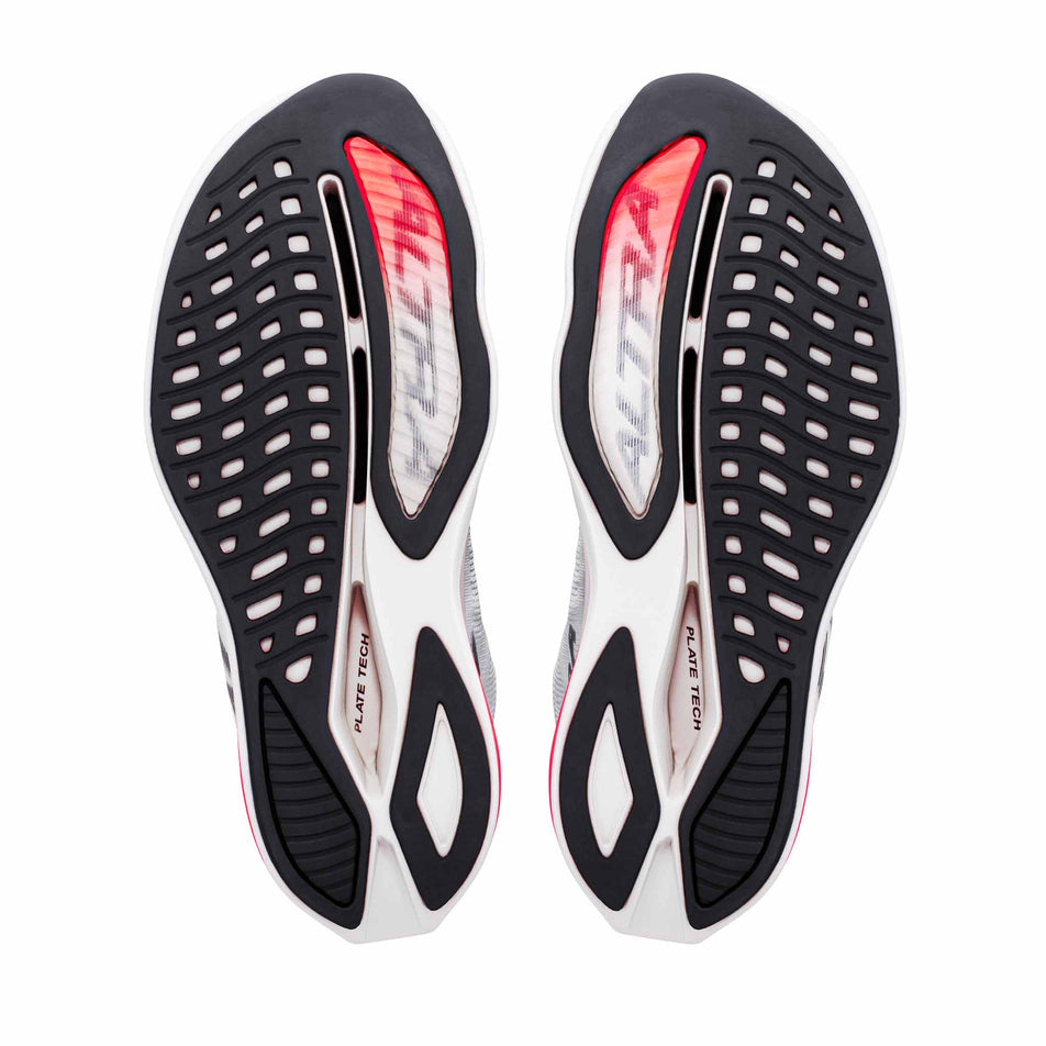 The outsoles of a pair of Altra Men's Vanish Carbon 3 Running Shoes in the White/Black/Fiery Coral colourway.