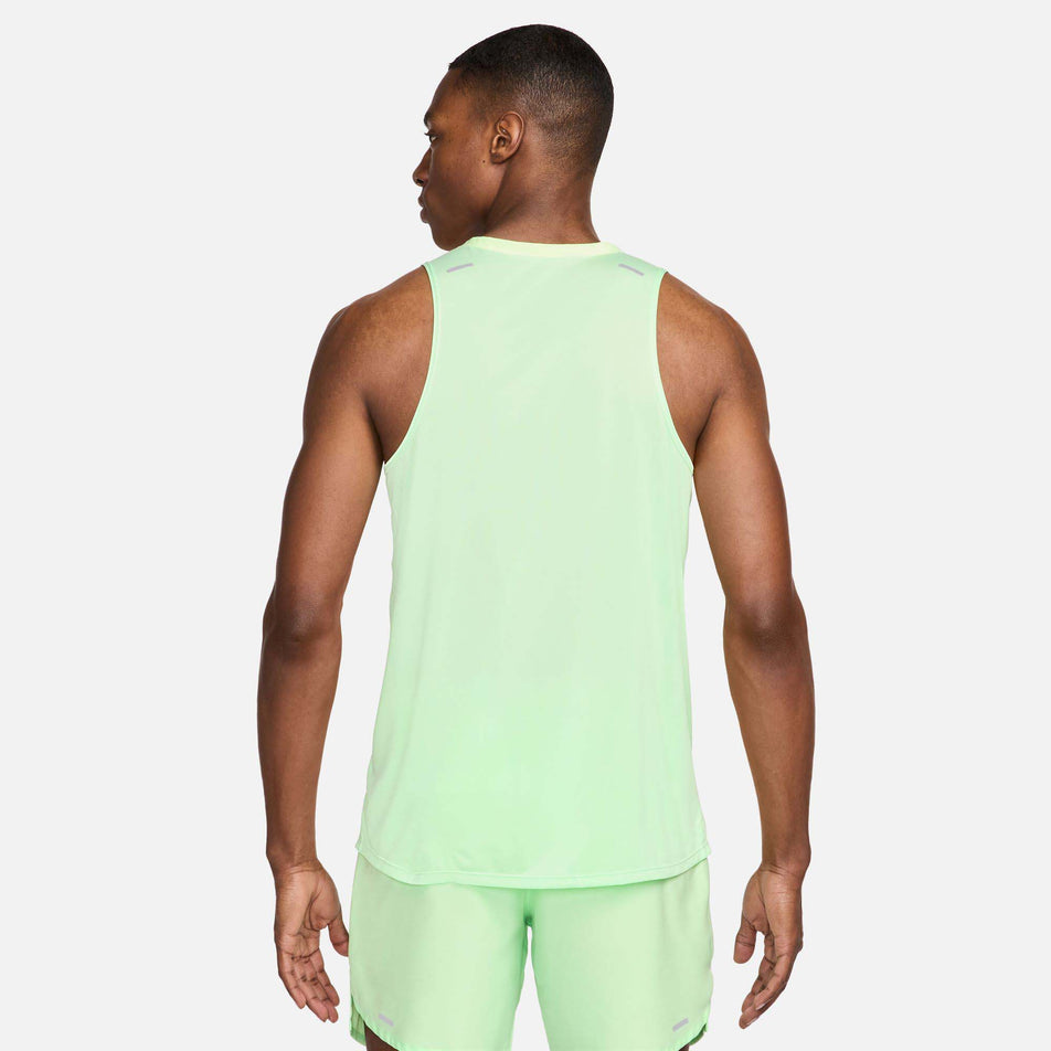 Back view of a model wearing a Nike Men's Rise 365 Dri-FIT Running Tank in the Vapor Green/Reflective Silv colourway. Model is also wearing green Nike shorts. (8215870767266)
