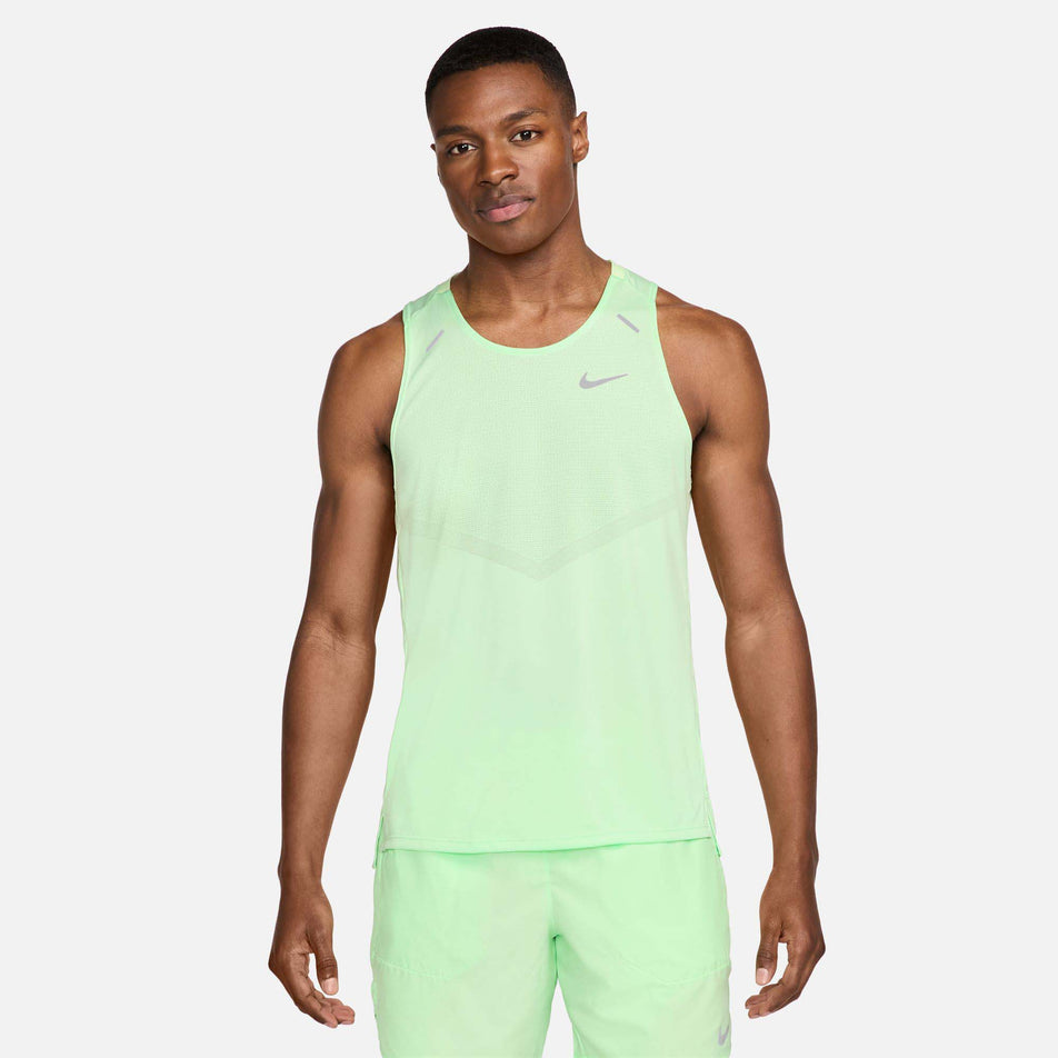 Front view of a model wearing a Nike Men's Rise 365 Dri-FIT Running Tank in the Vapor Green/Reflective Silv colourway. Model is also wearing green Nike shorts. (8215870767266)