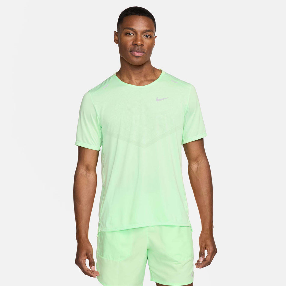 Front view of a model wearing a Nike Men's Rise 365 Dri-FIT Short-Sleeve Running Top in the Vapor Green/Reflective Silv colourway. Model is also wearing Nike running shorts. (8215872766114)