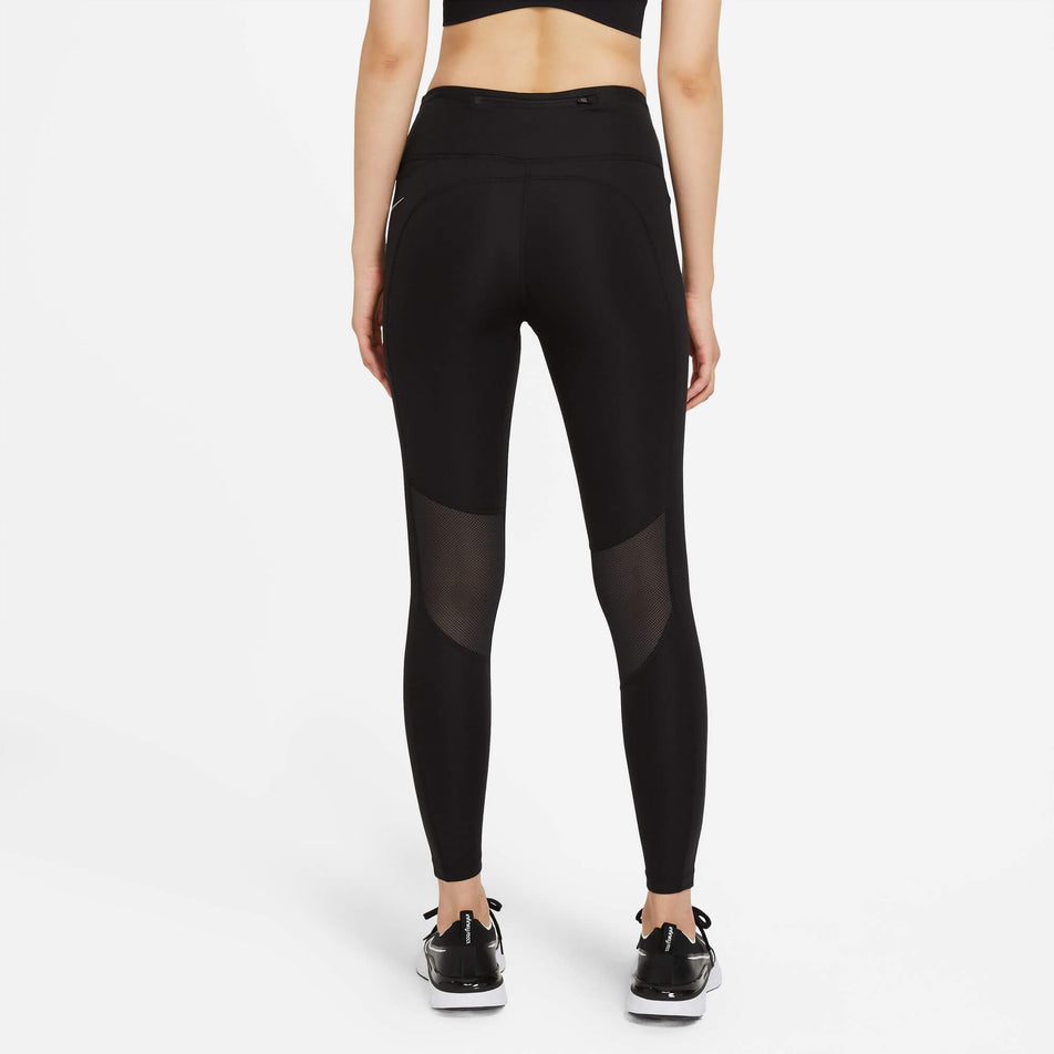 Back view of a model wearing a pair of Nike Women's Epic Fast Mid-Rise Pocket Running Leggings in the Black/Reflective Silv colourway (8049598562466)