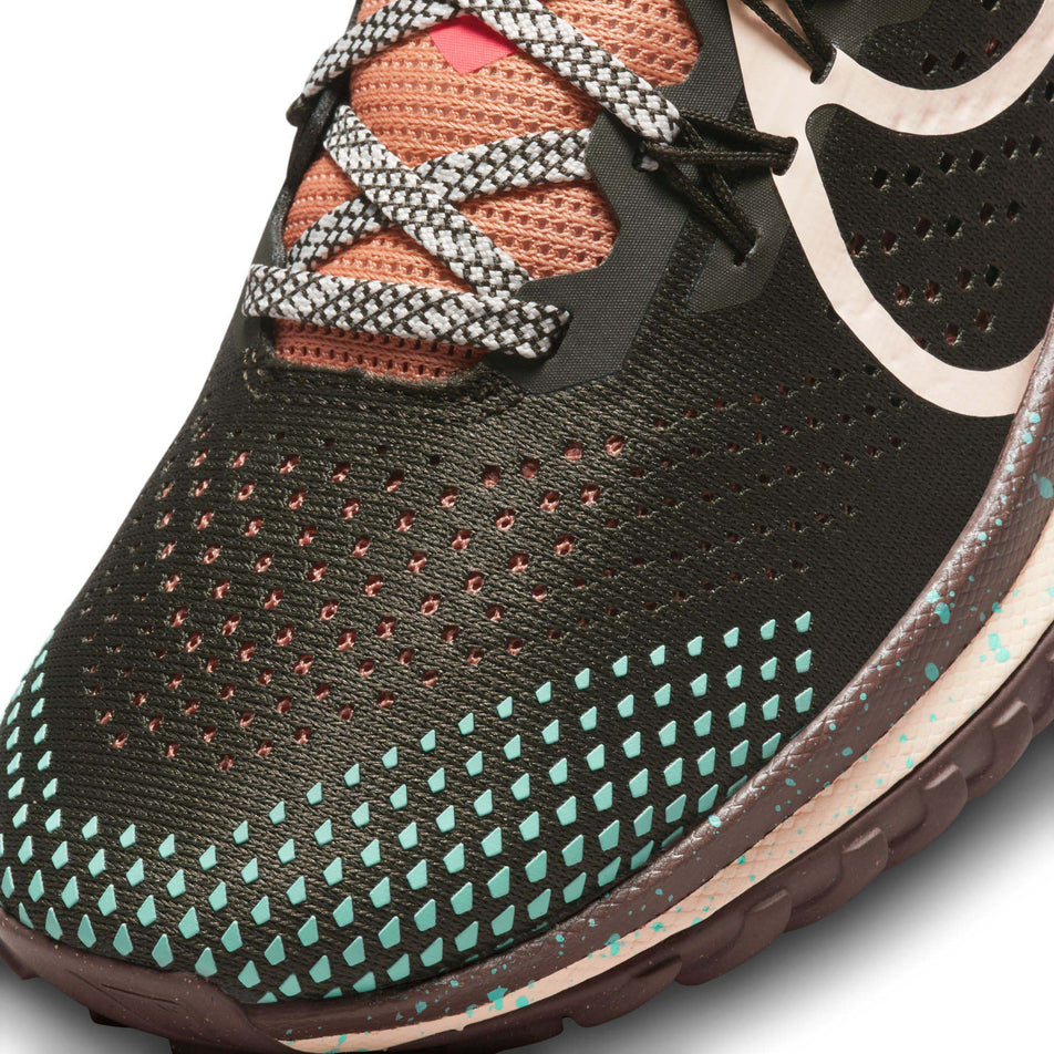 Lateral side of the toe box on the left shoe from a pair of Nike Pegasus Trail 4 Women's Trail Running Shoes in the Sequoia/Guava Ice-Amber Brown colourway (7995937587362)