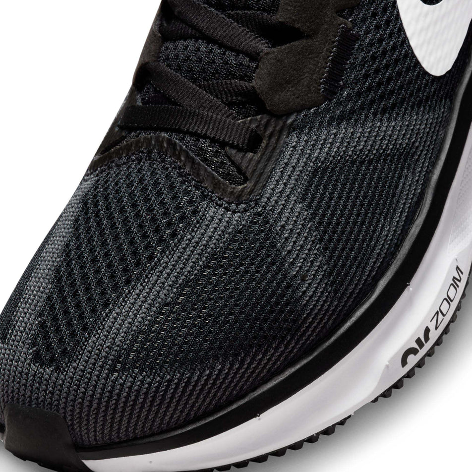 Lateral side of the toe box on the left shoe from a pair of Nike Women's Structure 25 Road Running Shoes in the Black/White-DK Smoke Grey colourway (8025972375714)