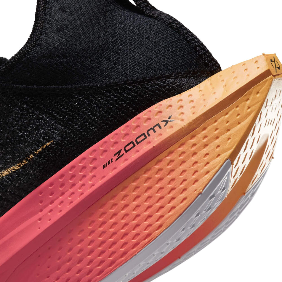 Lateral side of the heel unit on the left shoe from a pair of Nike Women's Alphafly 2 Road Racing Shoes in the BLACK/TOPAZ GOLD-SEA CORAL-WHITE colourway (7870344462498)