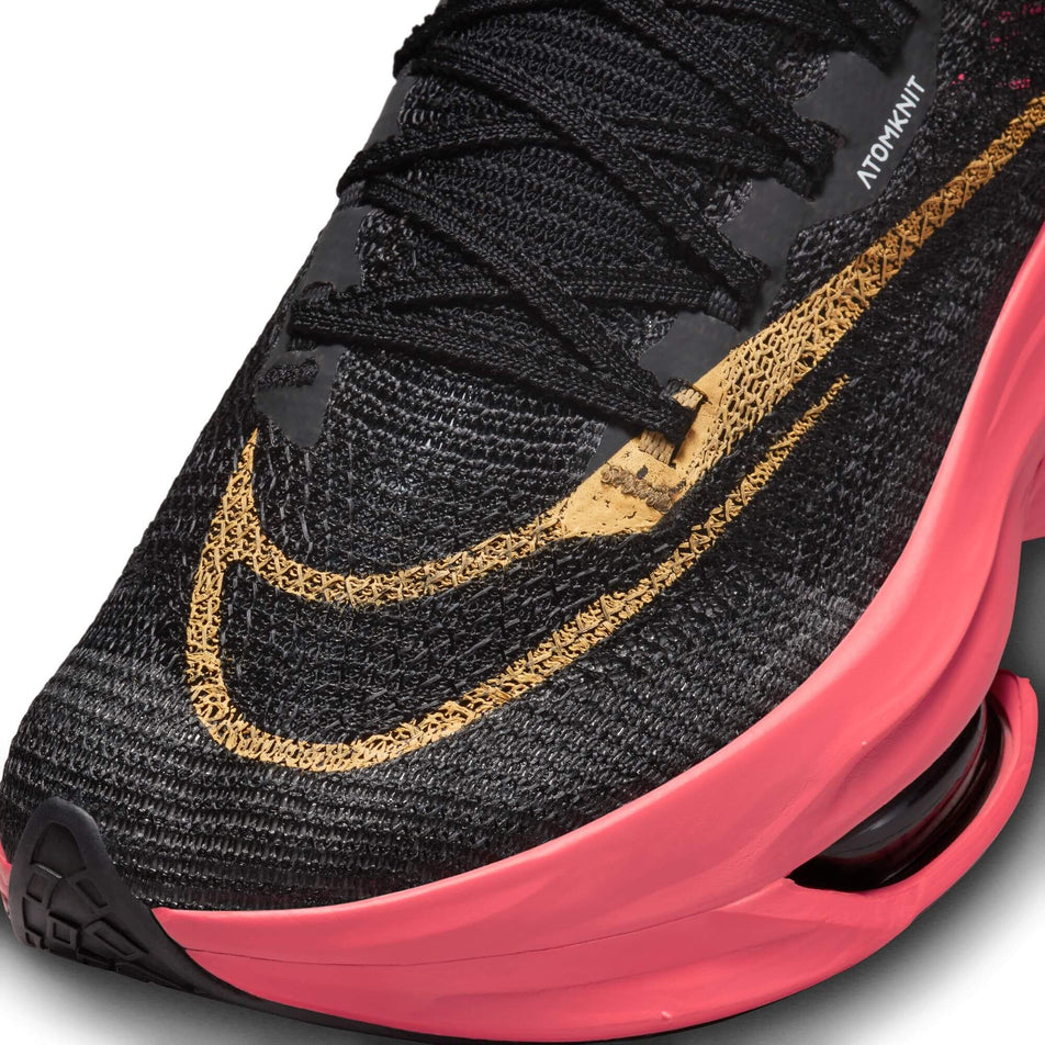 Lateral side of the toe box on the left shoe from a pair of Nike Women's Alphafly 2 Road Racing Shoes in the BLACK/TOPAZ GOLD-SEA CORAL-WHITE colourway (7870344462498)
