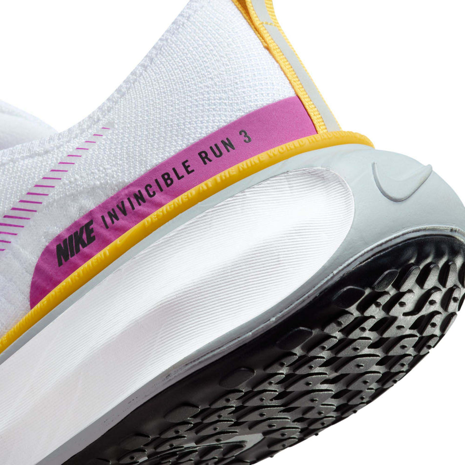 Lateral side of the back of the left shoe from a pair of Nike Women's Invincible 3 Road Running Shoes in the White/Vivid Purple-Vivid Sulfur colourway (7979350261922)