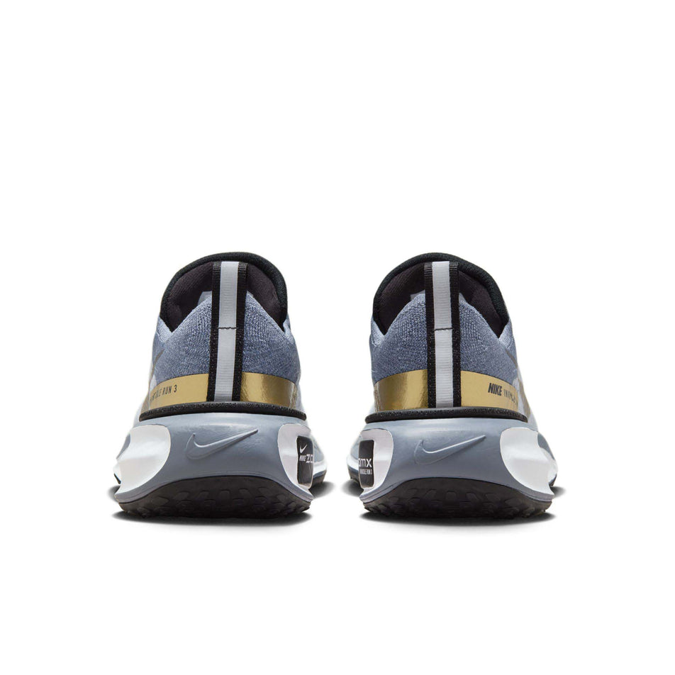 The back of a pair of Nike  Women's Invincible 3 Road Running Shoes in the Ashen Slate/Metallic Gold-Diffused Blue colourway (8070590333090)