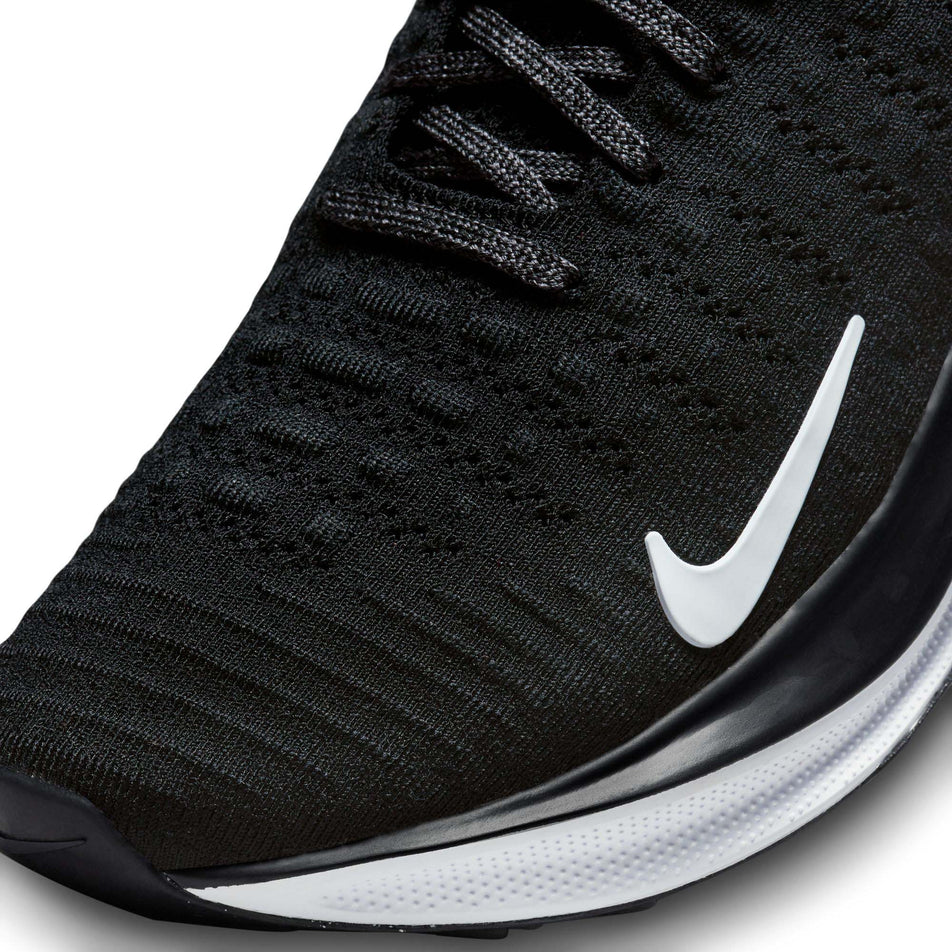 Lateral side of the toe box on the left shoe from a pair of Nike Women's Infinity RN 4 Road Running Shoes in the Black/White-Dark Grey colourway (7979380277410)