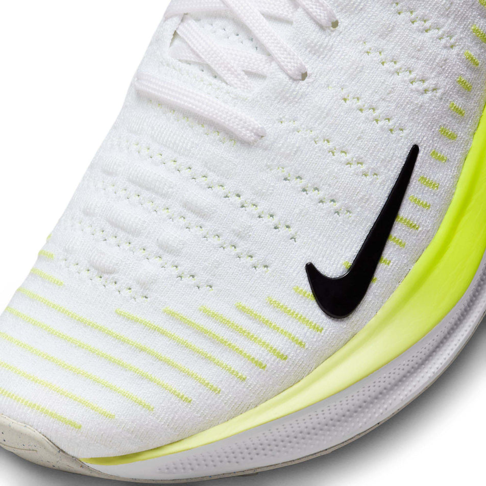 Lateral side of the toe box on the left shoe from a pair of Nike Women's Infinity RN 4 Road Running Shoes in the White/Black-LT Lemon Twist-Volt colurway (7979397054626)