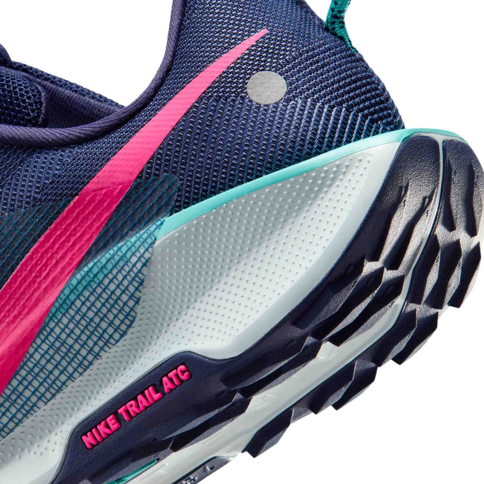 Close-up view of the rearfoot section of the shoe from a pair of Nike Men's Pegasus Trail 5 Trail Running Shoes in the Midnight Navy/Hyper Pink-Dusty Cactus colourway.