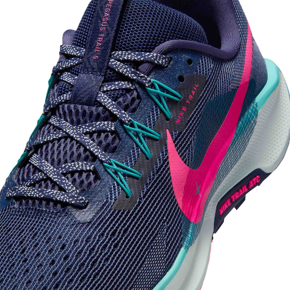 Close-up view of the upper of the left shoe from a pair of Nike Men's Pegasus Trail 5 Trail Running Shoes in the Midnight Navy/Hyper Pink-Dusty Cactus colourway.