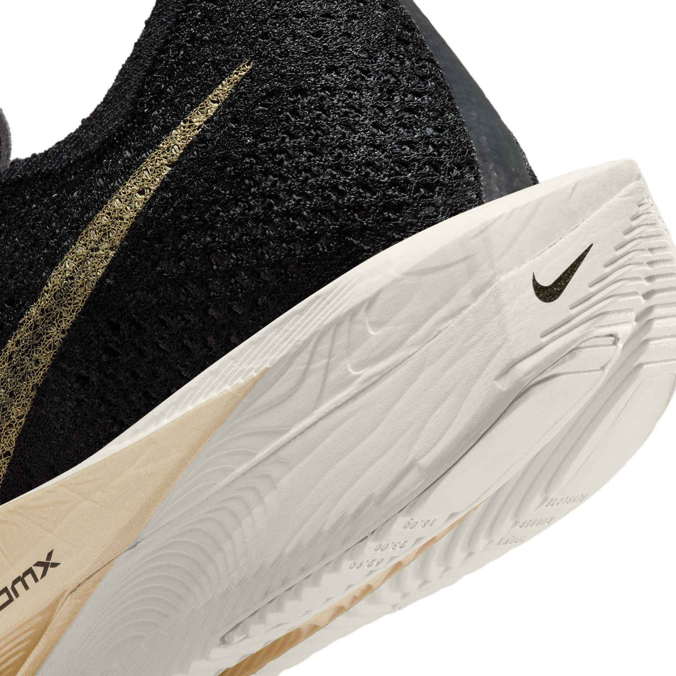 Lateral side of the back of the left shoe from a pair of Nike Men's Vaporfly 3 Road Racing Shoes in the Black/Mtlc Gold Grain-Black-Oatmeal colourway (8048741220514)
