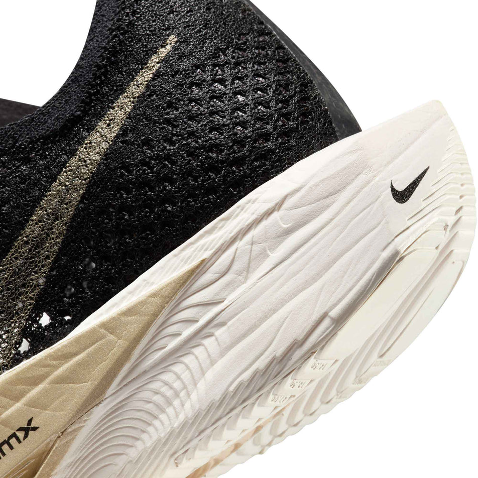 Lateral side of the back of the left shoe from a pair of Nike Women's Vaporfly 3 Road Racing Shoes in the Black/Mtlc Gold Grain-Black Oatmeal colourway (8070583582882)
