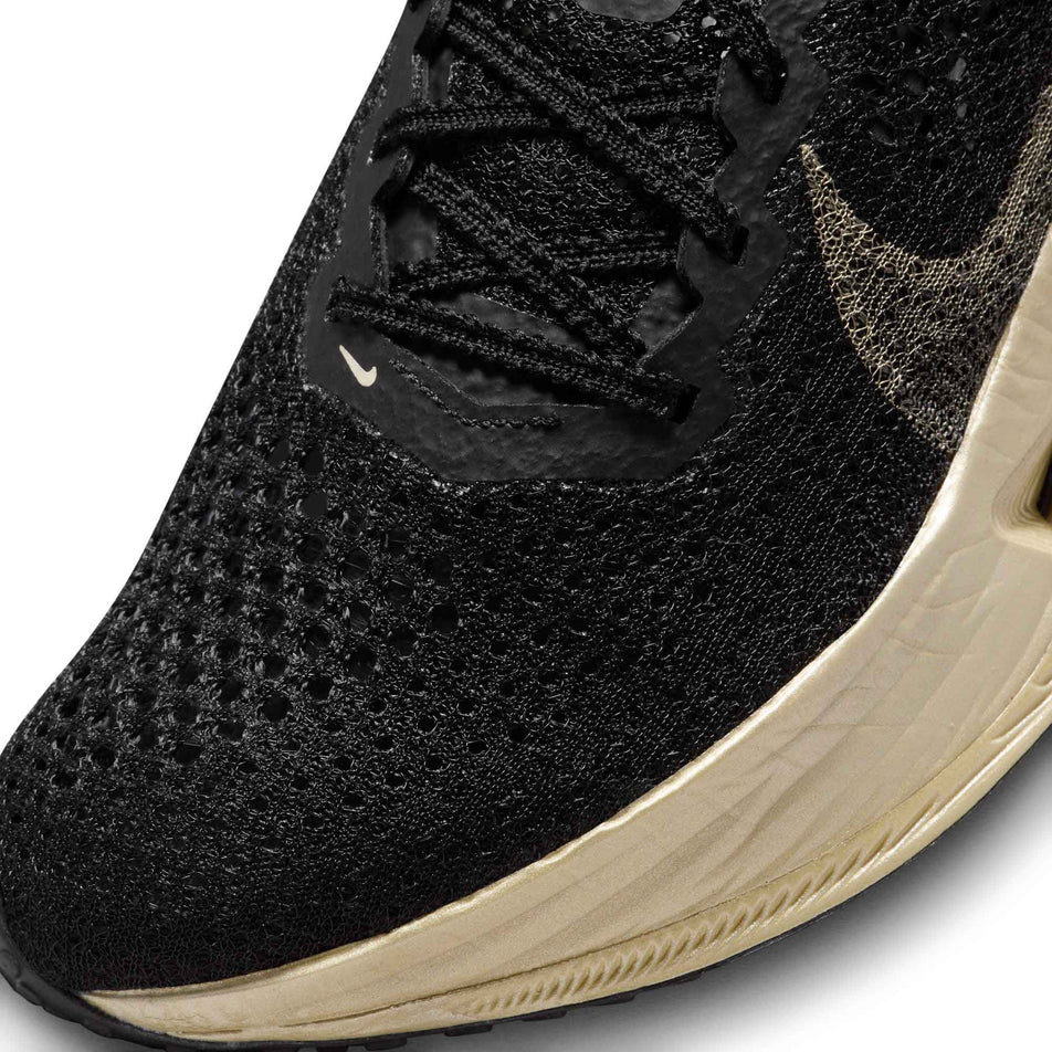 Lateral side of the toe box on the left shoe from a pair of Nike Women's Vaporfly 3 Road Racing Shoes in the Black/Mtlc Gold Grain-Black Oatmeal colourway (8070583582882)