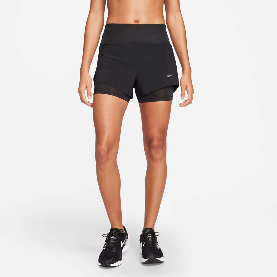 Front view of a model wearing a pair of Nike Women's Dri-FIT Swift Mid-Rise 3