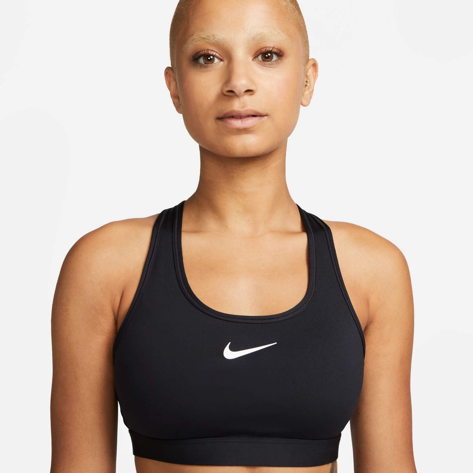 Front view of a model wearing a Nike  Women's Swoosh Medium Support Padded Sports Bra in the Black/White colourway (8140167086242)