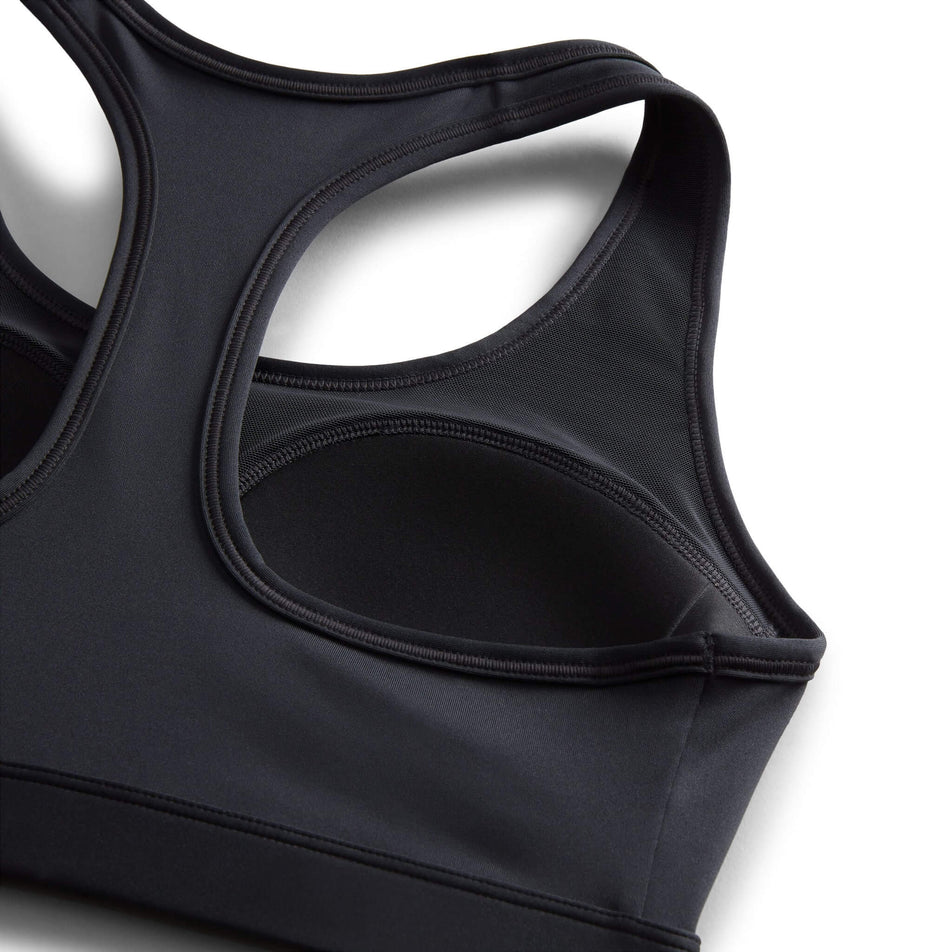 Close-up of the design details of the inner part of a Nike Women's Swoosh Medium Support Padded Sports Bra in the Black/White colourway. (8140167086242)