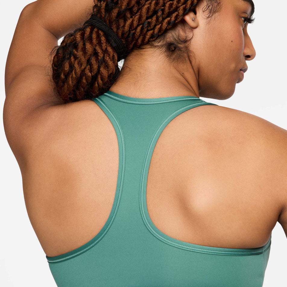 Close-up back view of a model wearing a Nike Women's Swoosh Medium Support Padded Sports Bra in the Bicoastal/White colourway. (8299354063010)