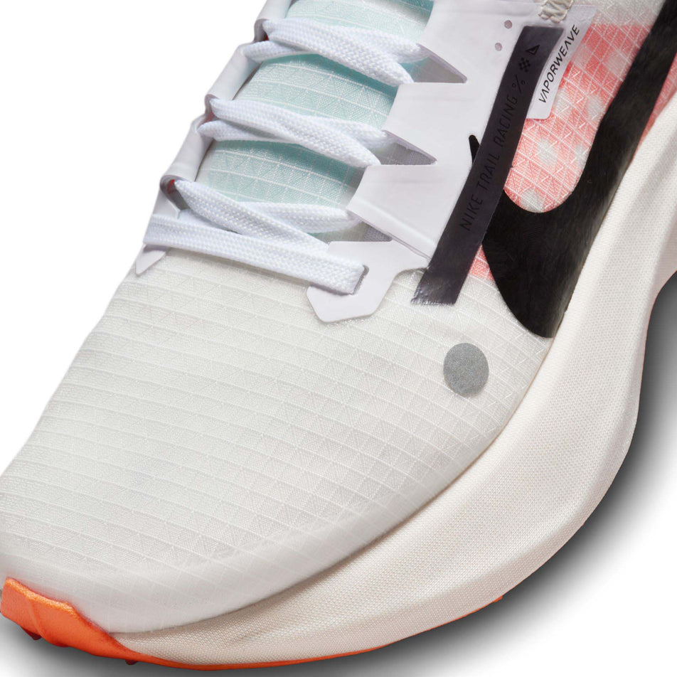 Lateral side of the toe box on the left shoe from a pair of Nike Women's Ultrafly Trail Running Shoes in the White/Black-Total Orange-Pale Ivory colourway  (7995936637090)