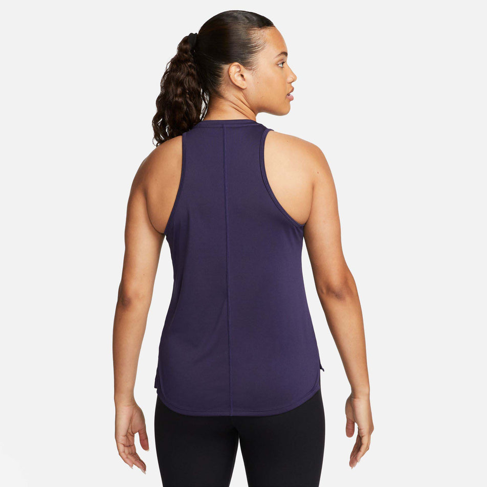 Back view of a model wearing a Nike Women's Dri-FIT Swoosh Tank Top in the Purple Ink/Disco Purple colourway (7980177719458)