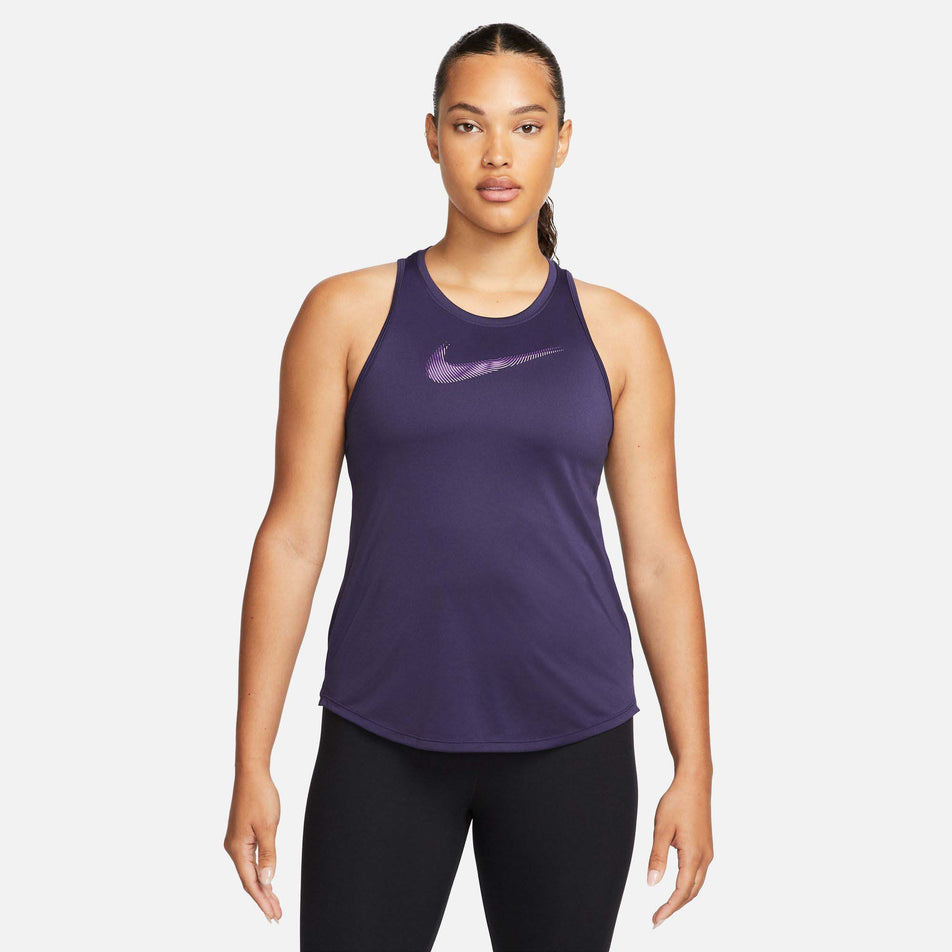 Front view of a model wearing a Nike Women's Dri-FIT Swoosh Tank Top in the Purple Ink/Disco Purple colourway (7980177719458)
