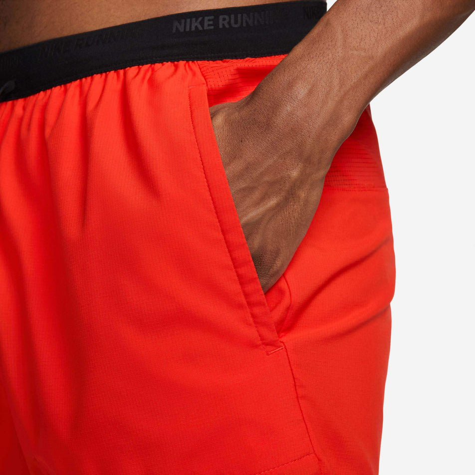 Close-up left-side view of a model wearing a pair of Nike Men's Dri-FIT Stride Kipchoge 7