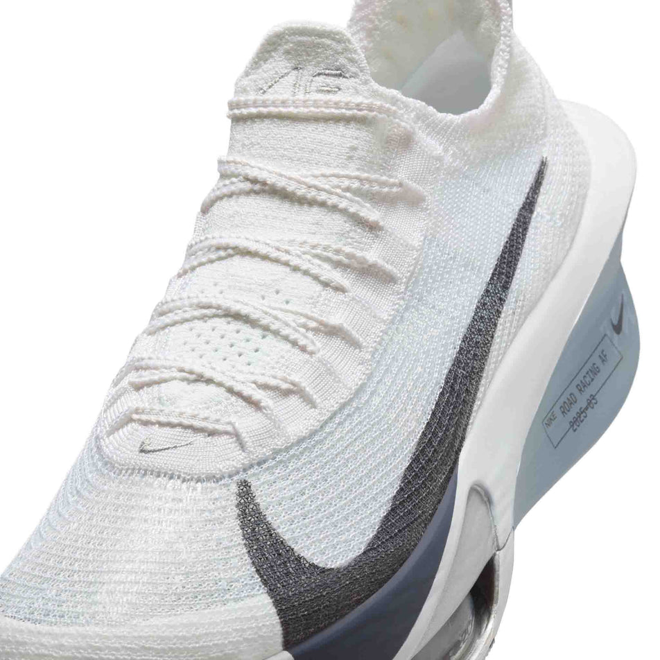 Close up of the upper of the left shoe from a pair of Nike Men's Alphafly 3 Road Racing Shoes in the White/Gridiron-Pure Platinum colourway. (8613778915490)