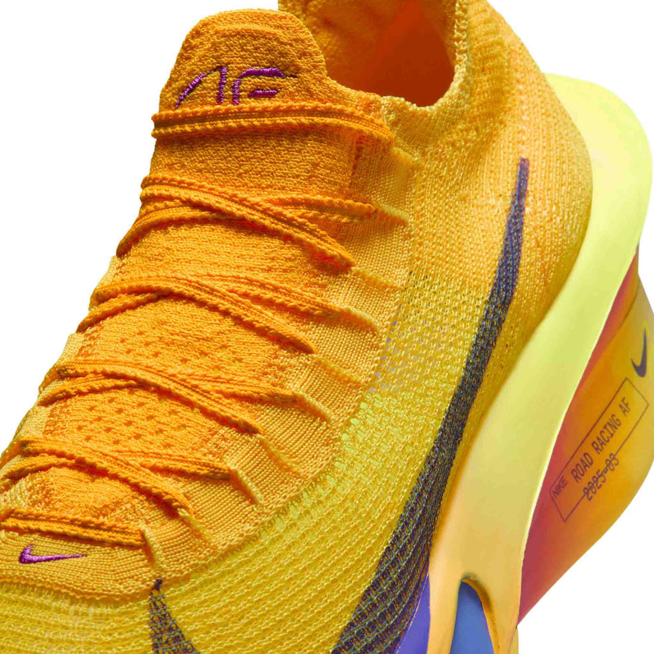 Close-up view of the upper of the left shoe from a pair of Nike Men's Alphafly 3 Running Shoes in the Laser Orange/Indigo Burst-Citron Pulse colourway.