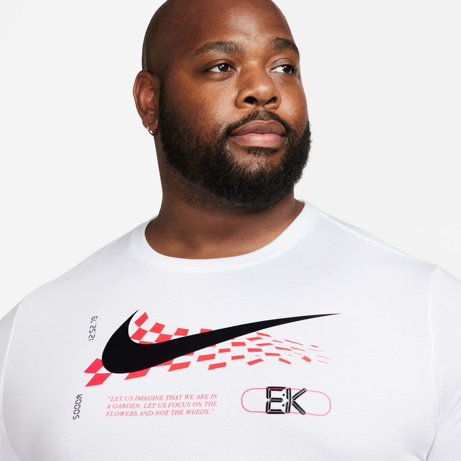 Close-up front view of a model wearing a Nike Men's Eliud Kipchoge Dri-FIT Running T-Shirt in the White colourway. Upper half of the t-shirt is visible in the image.  (8029388964002)