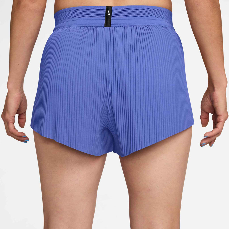 Back view of a model wearing the Nike Women's AeroSwift Dri-FIT ADV Mid-Rise Brief-Lined 3
